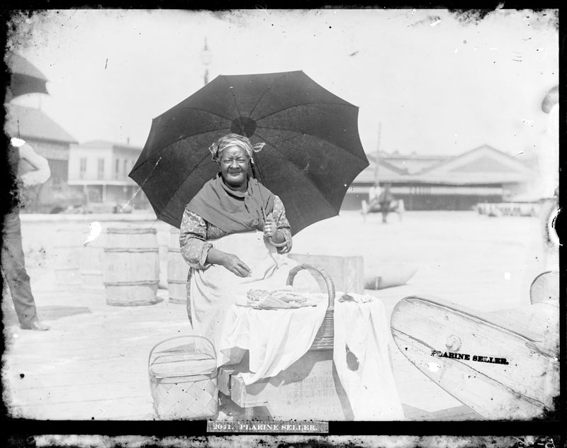 Praline Seller in Sun. George François Mugnier, c. 1885. Collodion on glass plate, 8 x 10 inches. Louisiana State Museum 09813.0022.