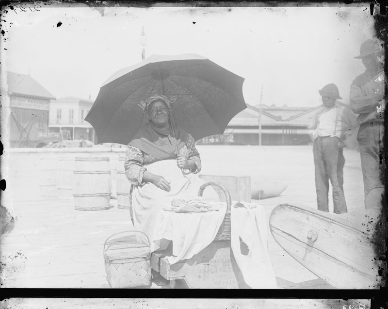 Praline Seller in Shadows. George François Mugnier, c. 1885. Collodion on glass plate, 8 x 10 inches. Louisiana State Museum 09813.0023.