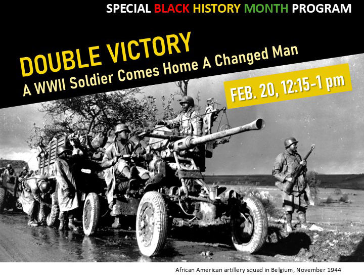 Black-and-white historical photograph of an African American U.S. Army artillery squad operating a large field gun beside a military vehicle on a muddy road in Belgium during World War II, November 1944.