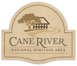 Logo for the Cane River National Heritage Area, featuring a stylized tree, historic building and winding river above the organization’s name on a beige, arch-shaped background.