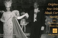 Black-and-white photograph of a formal Black Carnival ball. A young woman wearing an ornate crown, embellished gown, long gloves, and holding a decorative scepter is escorted by an older man in a tuxedo and white gloves as they walk across a ballroom floor. Dancers in matching costumes stand behind them beneath draped curtains. Overlaid gold text reads, “Origins of New Orleans Black Carnival Society: The Story of the Illinois Clubs,” with The Presbytère logo. A caption at bottom left identifies the scene as