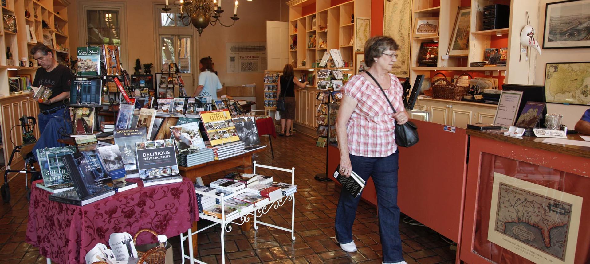 Photograph of customer browsing a gift shop located in the Lower Pontalba Building.