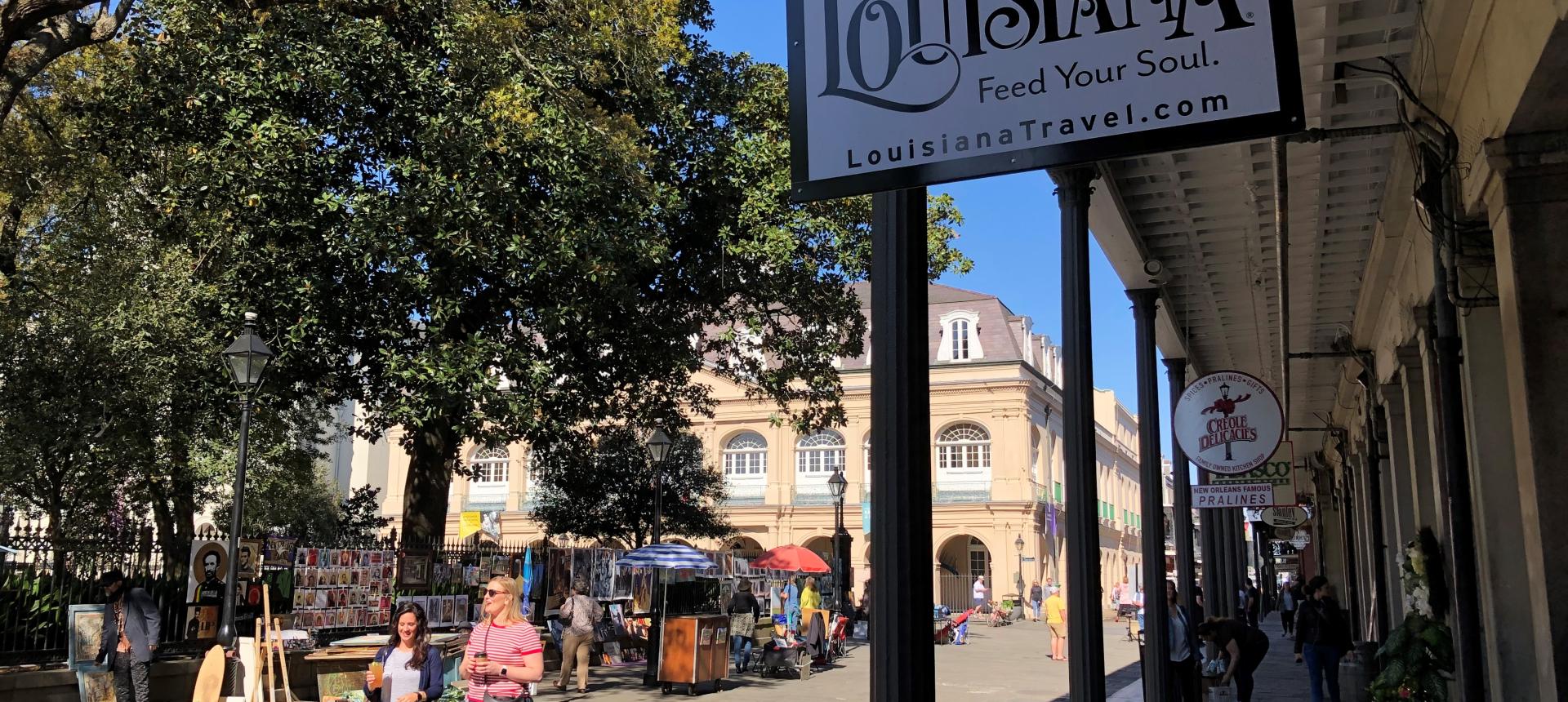 photograph of a bustling sidewalk outside the Lower Pontalba on Jackson Square