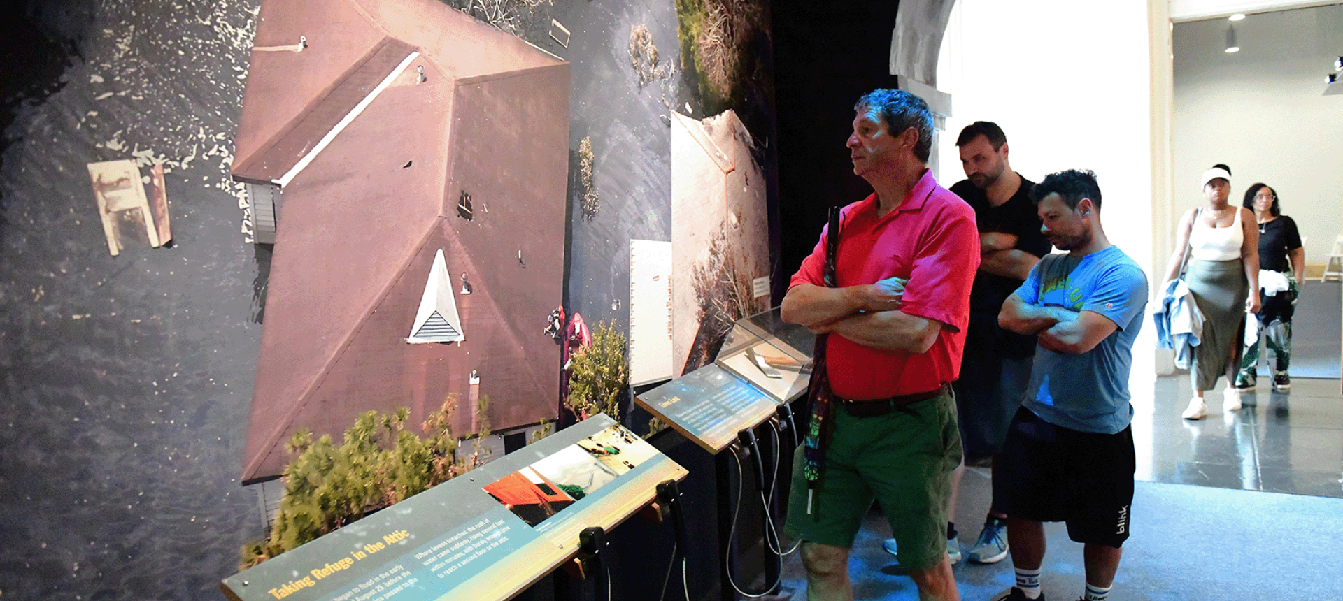 Visitors explore the exhibition Living with Hurricanes: Katrina and Beyond 