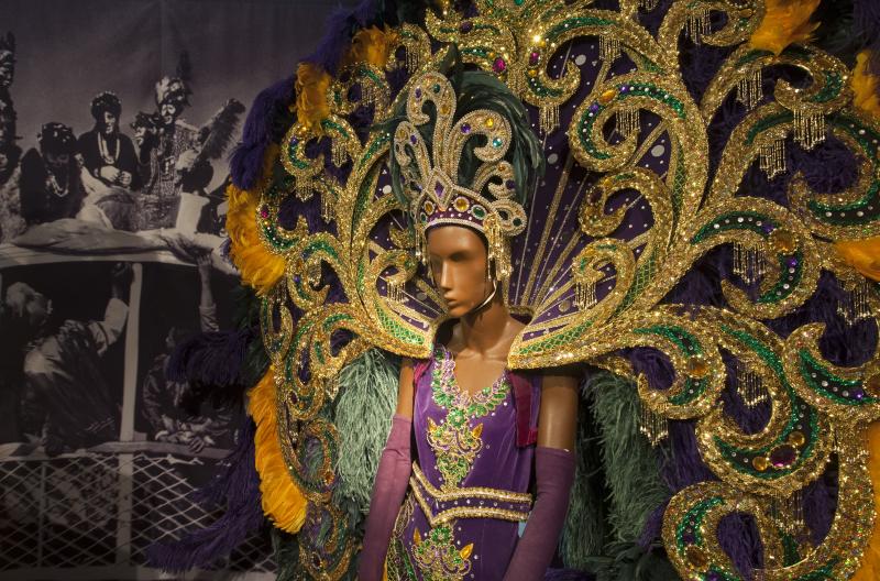 Purple, green, and gold float costume inside the exhibition Mardi Gras in Louisiana located at the Presbytère on Jackson Square