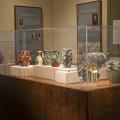 madame john's Pottery exhibit under a glass case.