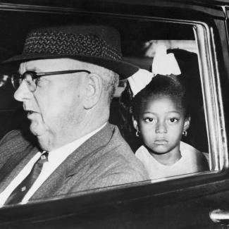 Gail Etienne being driven to school by federal marshals in 1960.